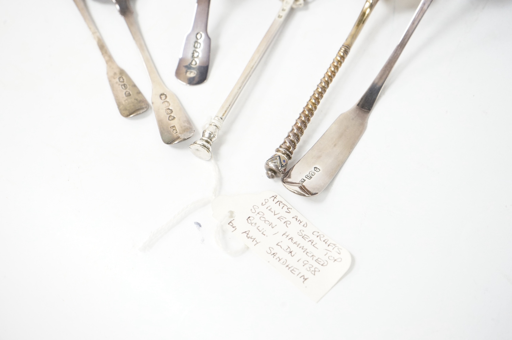 A George VI Arts & Crafts silver seal top spoon by Amy Sandheim, London, 1948, 14.2cm, a 19th century Russian 88 zolotnik and enamel spoon, assay master B.C, 1874, a 19th century silver caddy spoon and three silver ladle